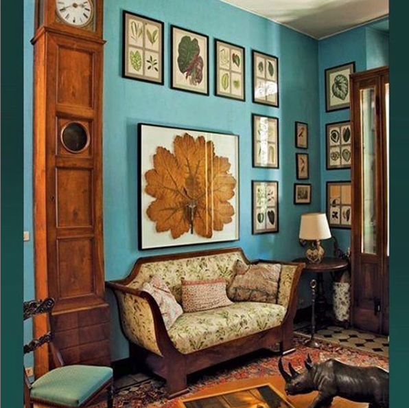 antique furniture antique wall art against teal wall