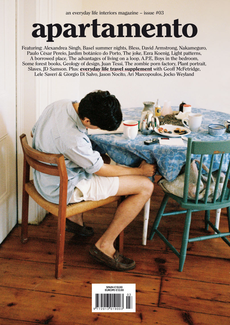 Magazine with guy sitting at table looking underneath the table