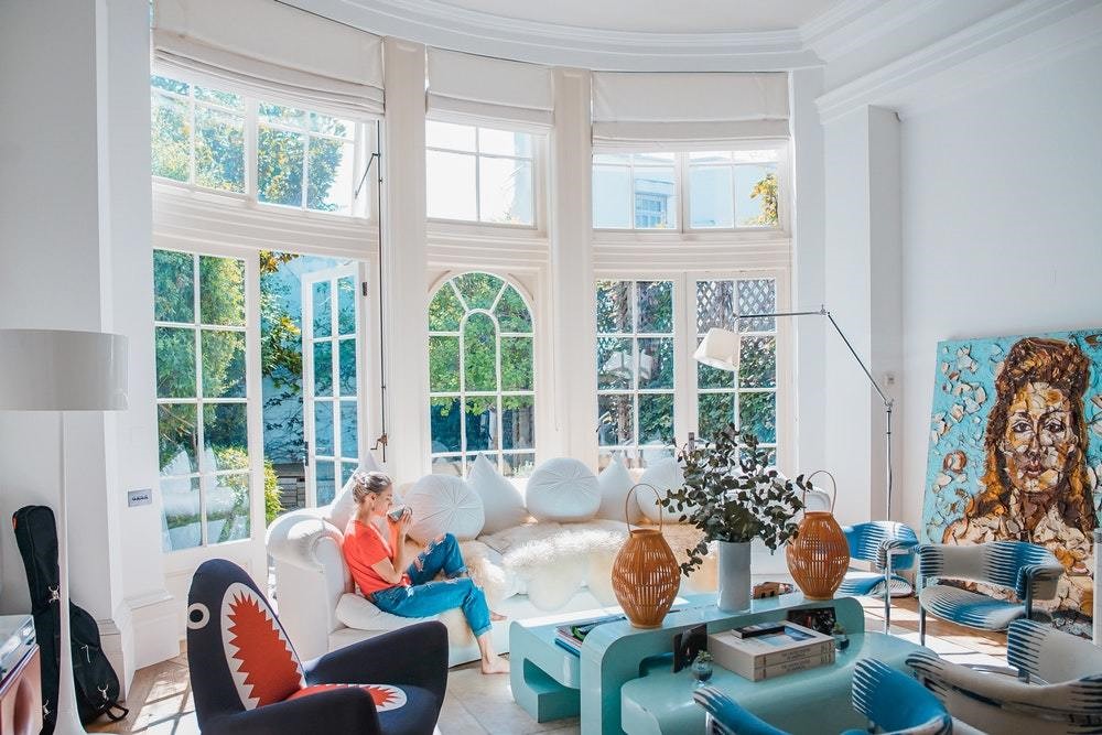 blue furniture in blue eclectic room with large windows