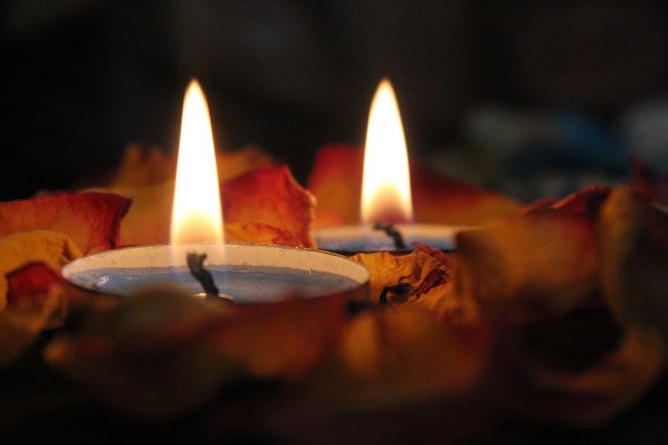 burning candles wrapped in fall leaves