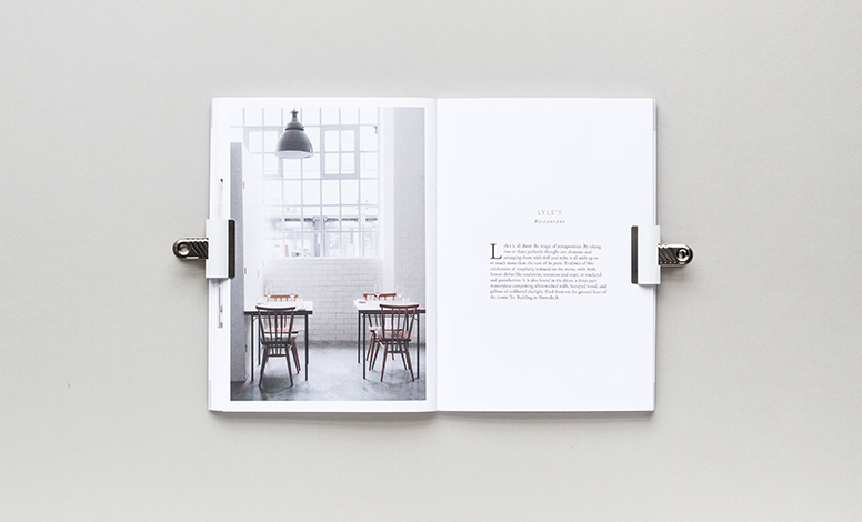 inside of read cereal magazine is a picture of a table and light with chairs