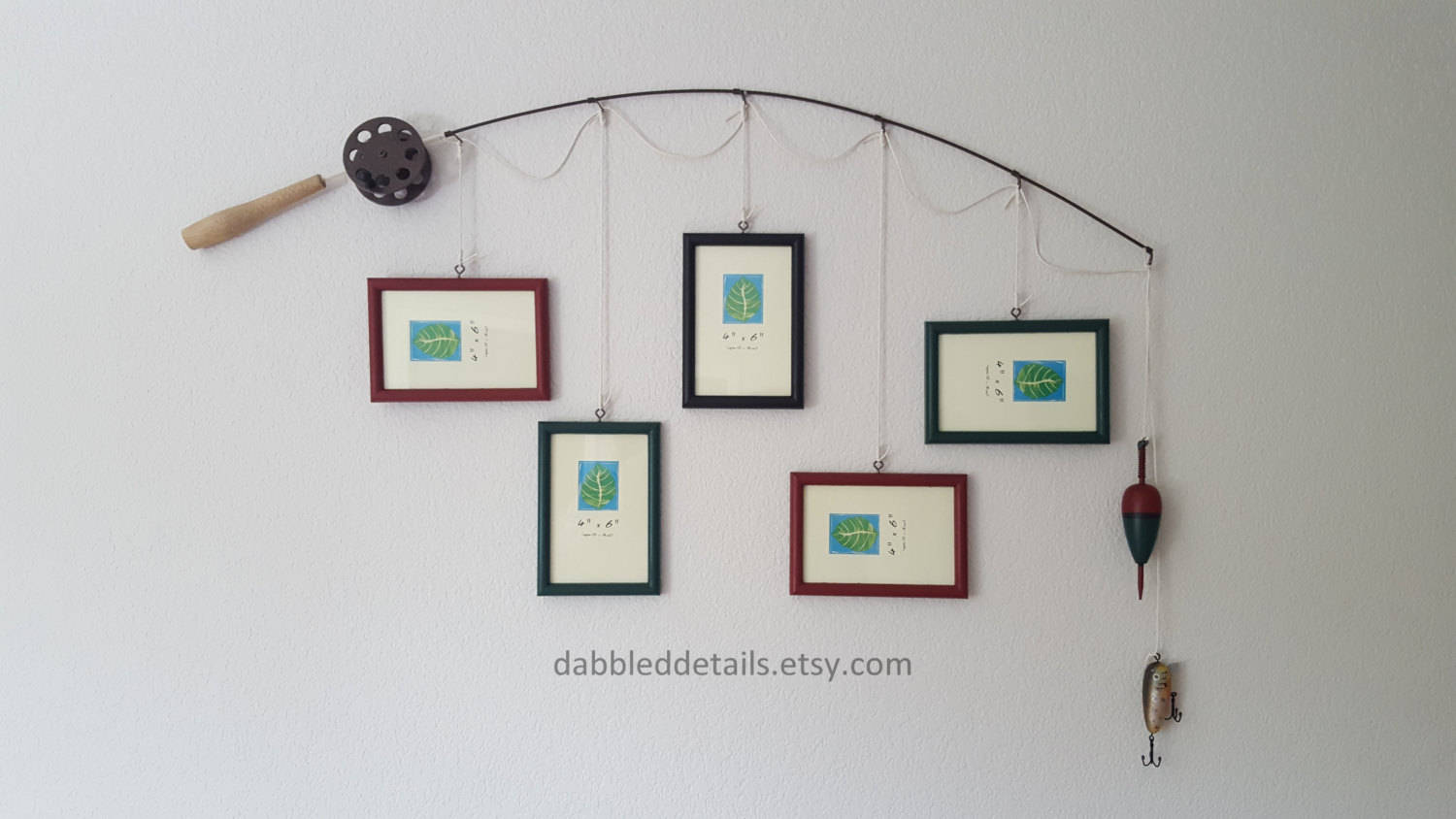 Fishing pole frame on wall with pictures