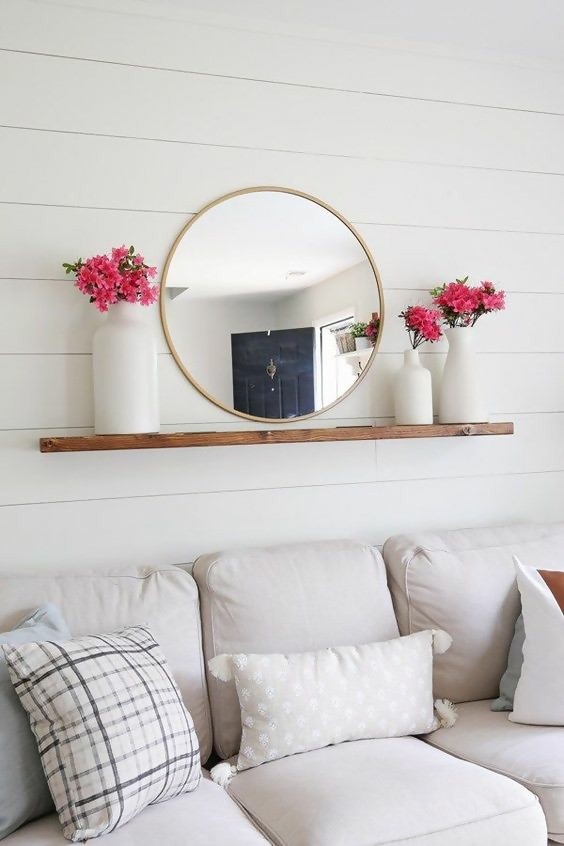 floating wood shelf with mirror and flower vases