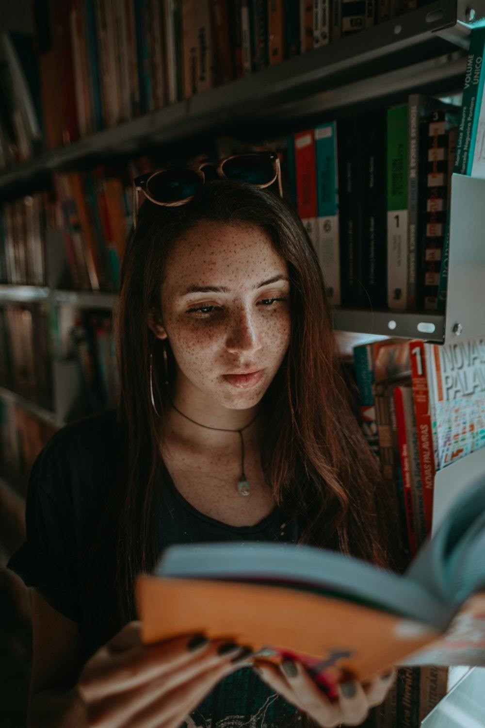 girl reading book in a library