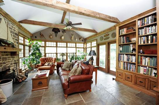 Outdoorsy lodge with antlers on wall and book shelf