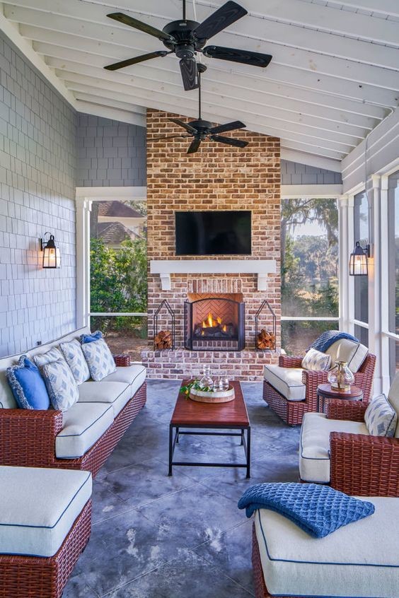 indoor outdoor sunroom with brick wall and flat screen