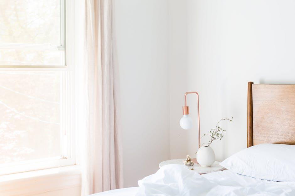 rose gold nightstand in a white room