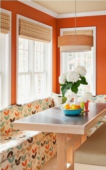 orange wall paint against white sofa with with orange accents