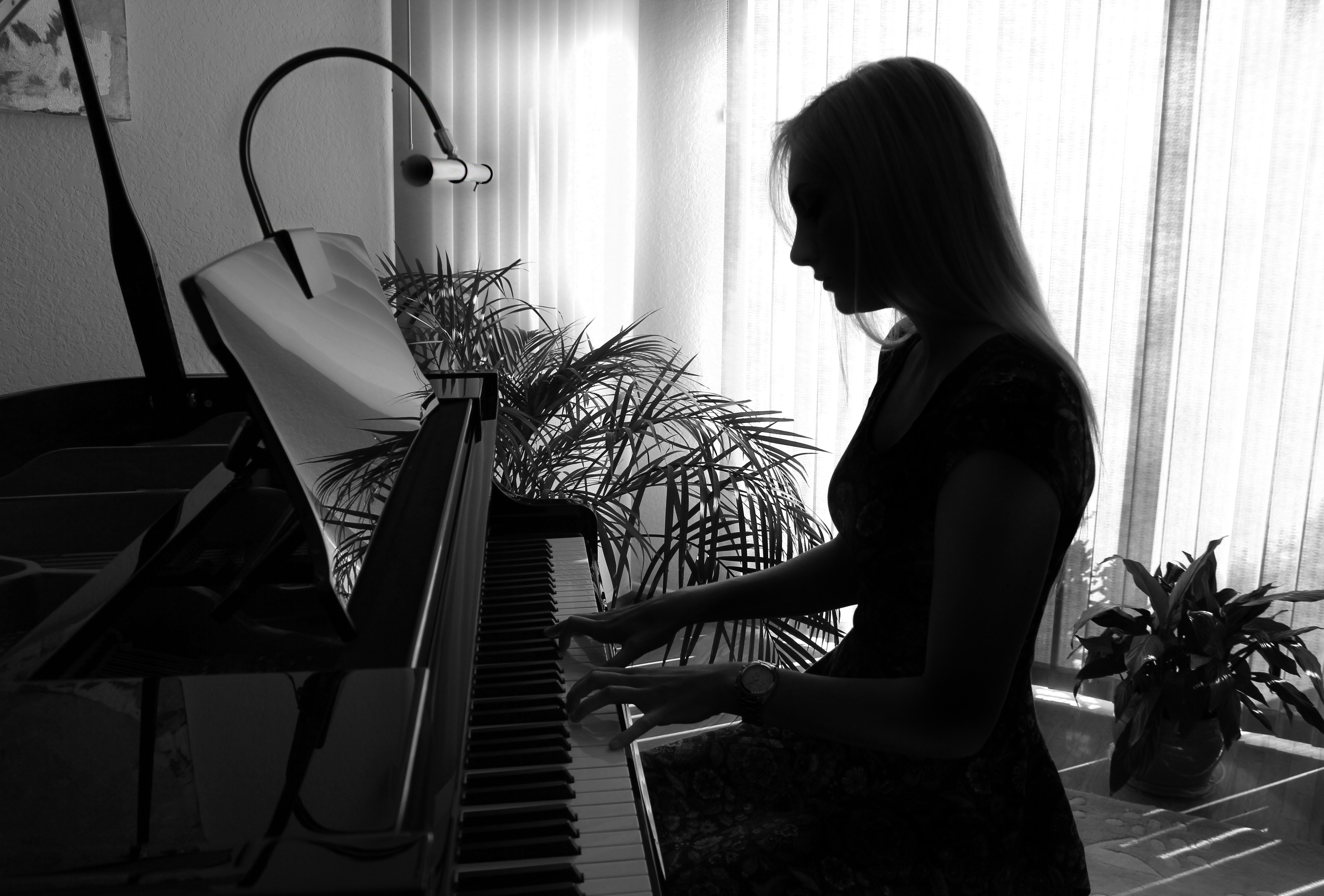 woman playing piano in the dark