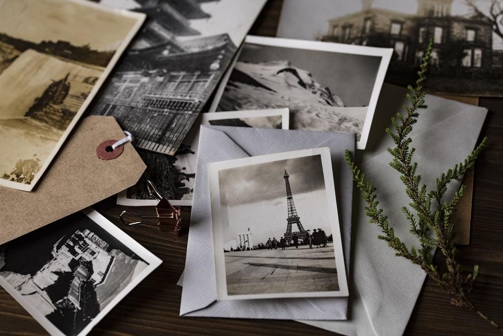 eiffel tower physical photo in black and white with various other physical pictures in black and white