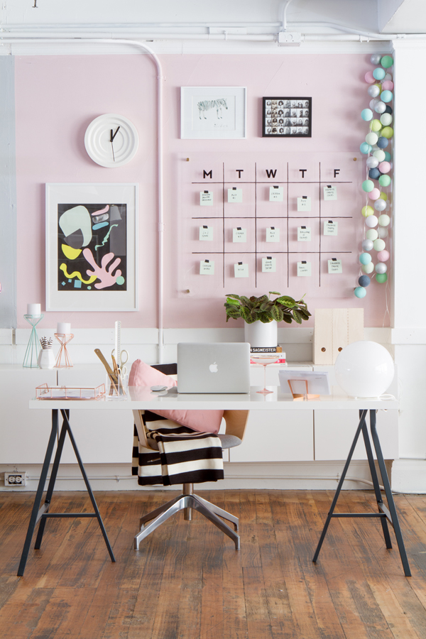 Office with pink wall and desk with chair