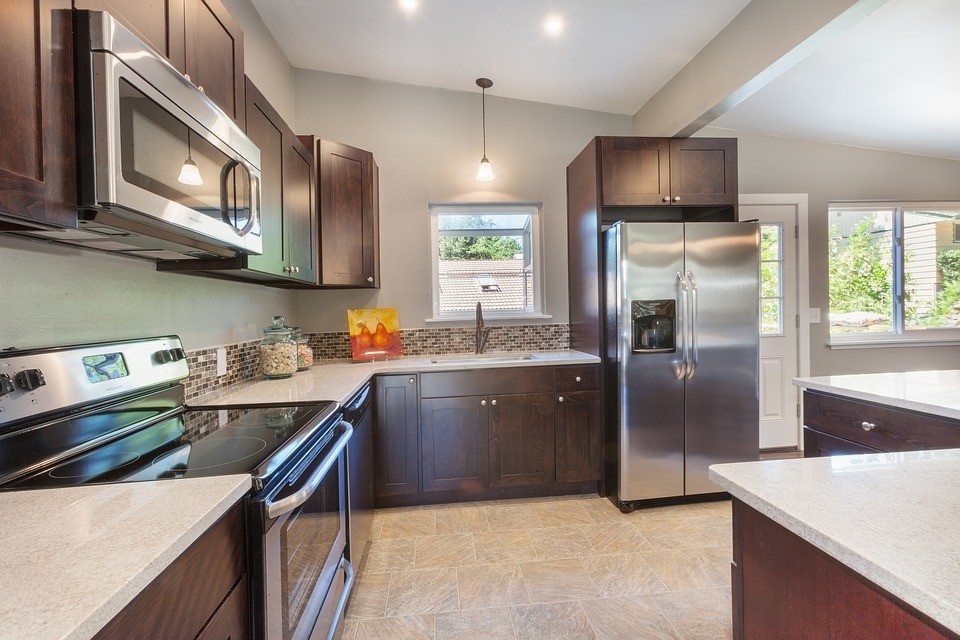 quartz countertop kitchen with brown cabinets