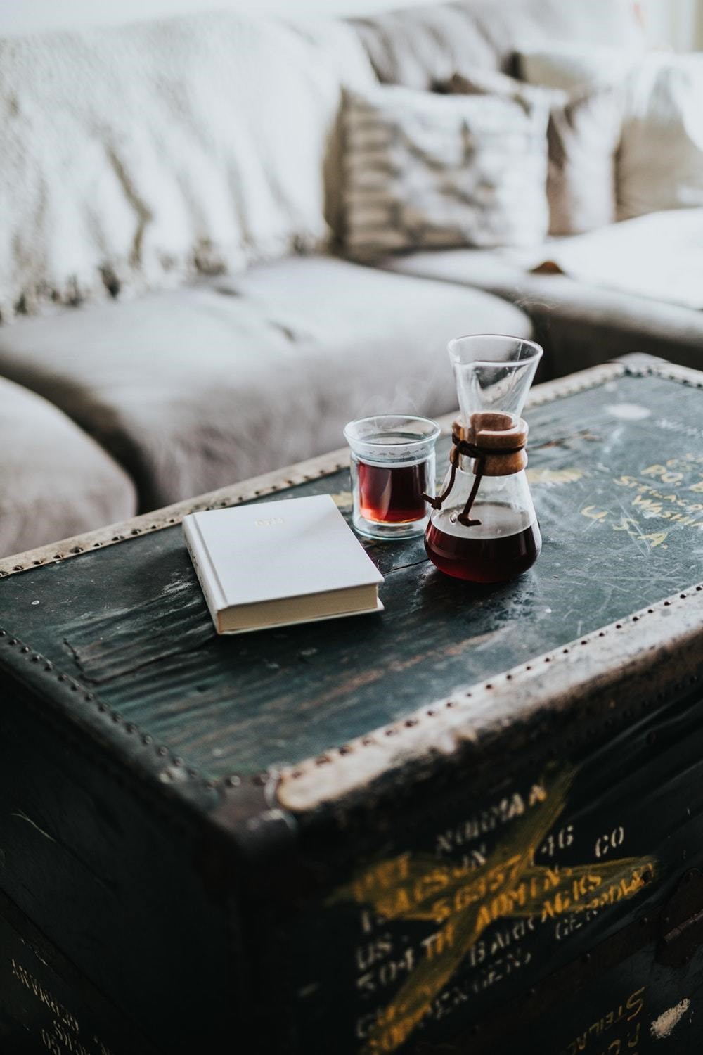 rustic old chest coffee table with wine and a book