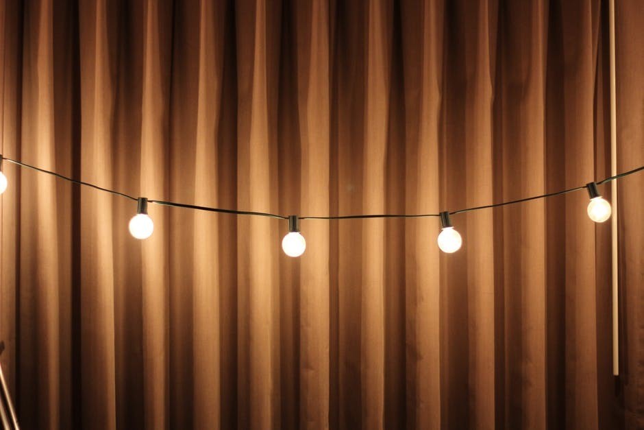 string lights against a brown curtain