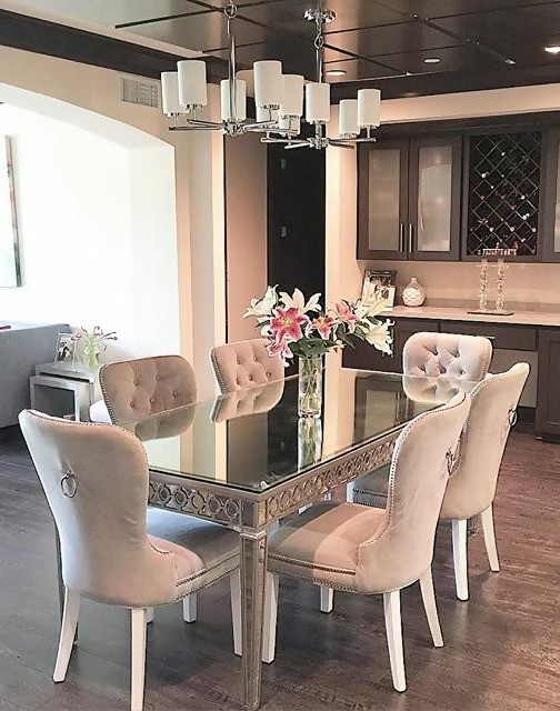 super nice dining room with glass and chandelier