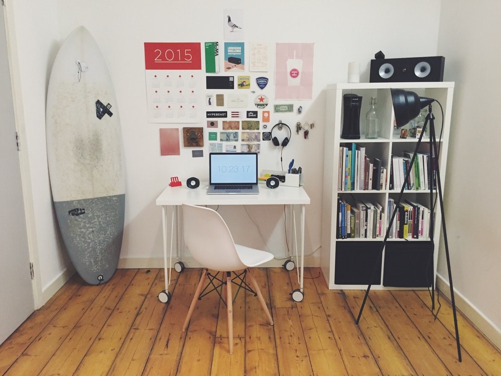 surfboard white wall office desk space