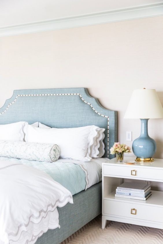 white bedroom with white bed and light blue room