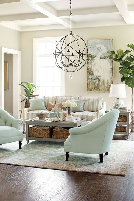 white living room with jade living room chairs and contemporary light fixture