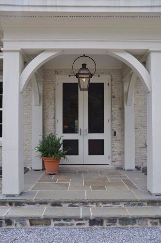 white modern front door with chandelier