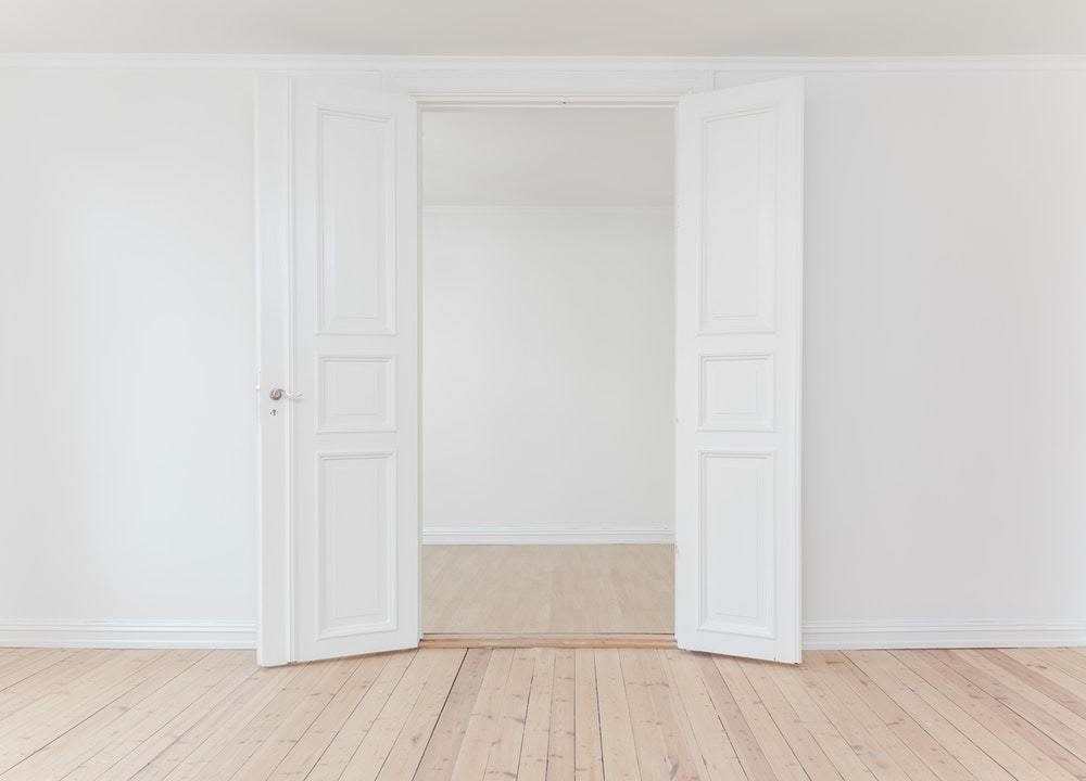 white new closet with plain wood floor