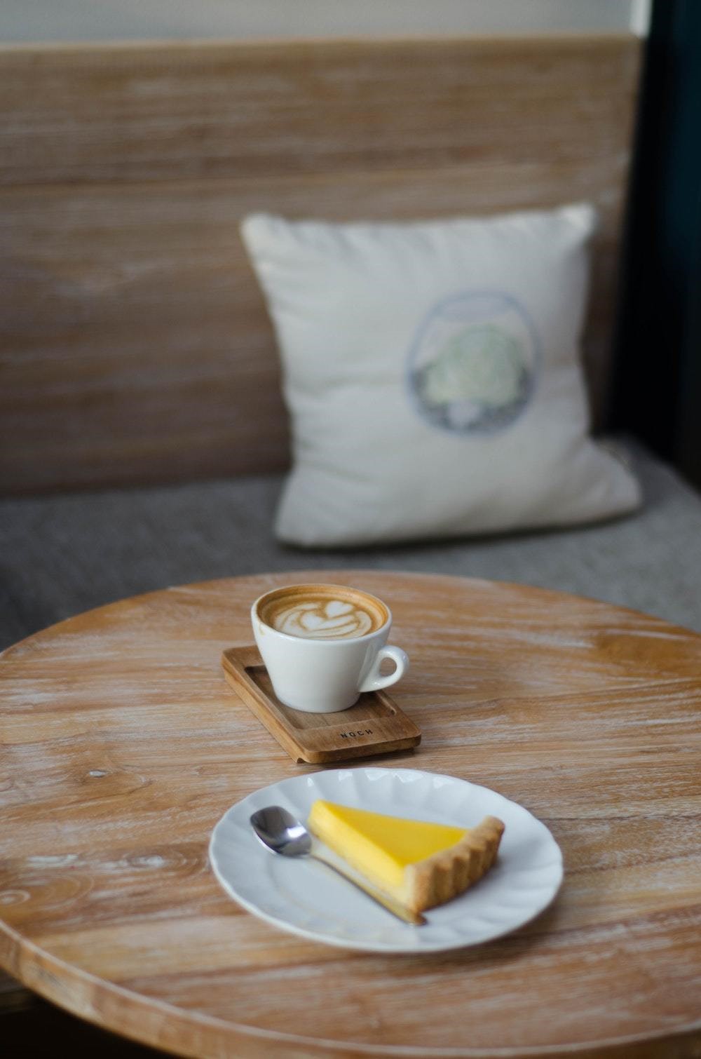 wooden coffee table with coffee and pie